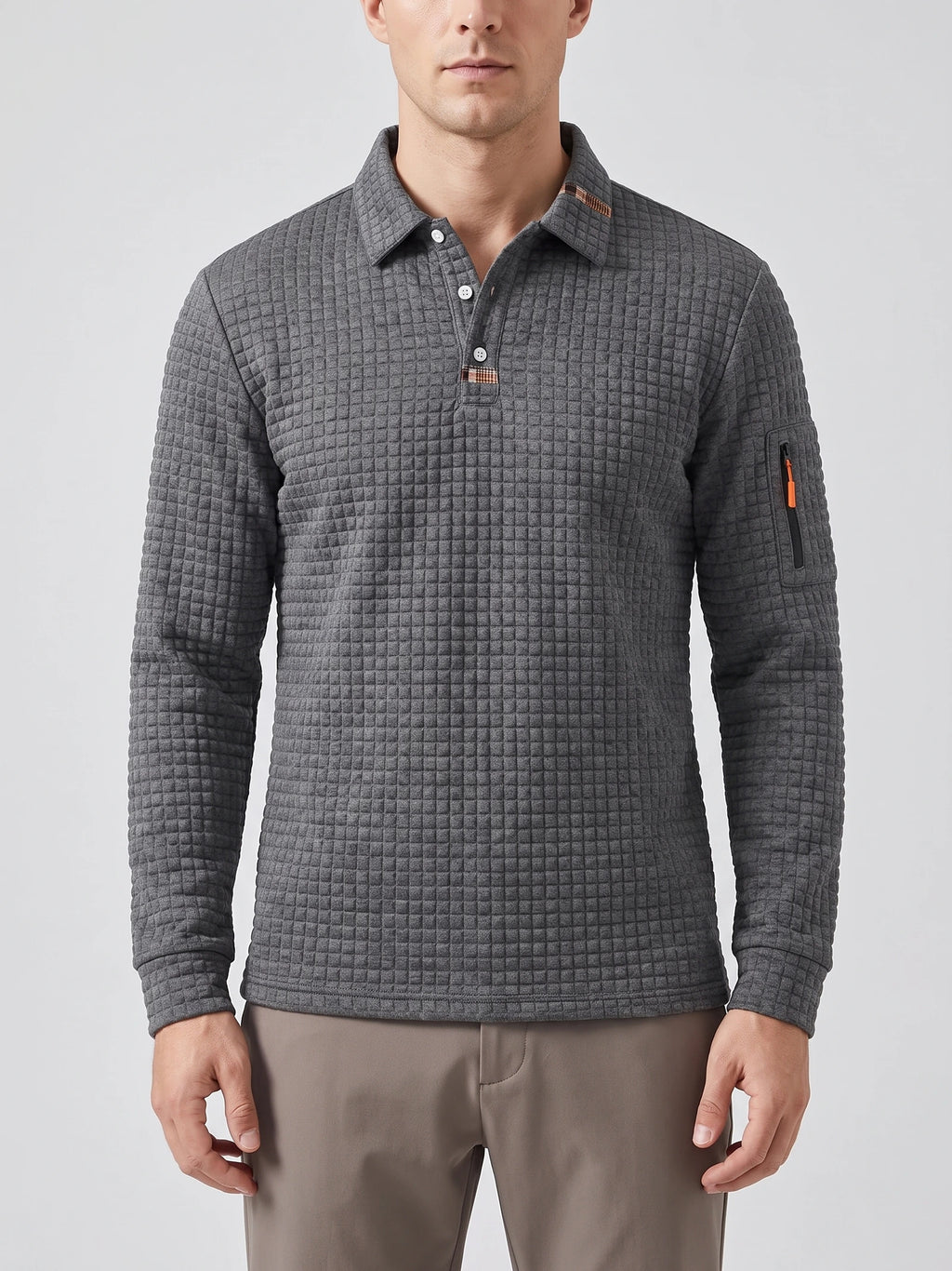 Front studio view of a model wearing a Gray long sleeve polo with a textured grid knit, button placket, and sleeve zip pocket.