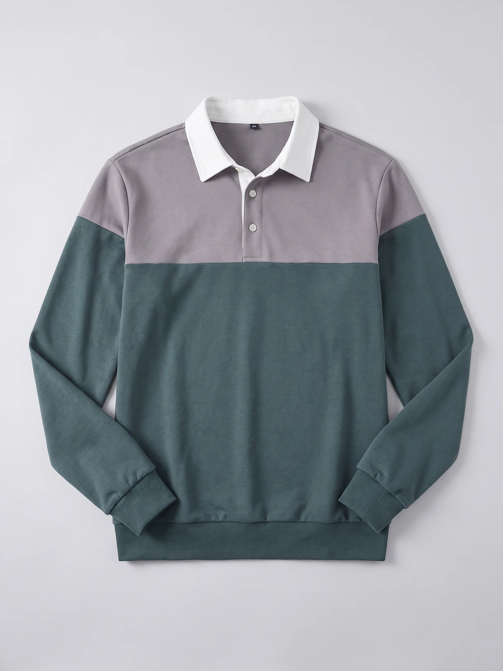 Gray Long Sleeve Polo laid flat, featuring a pointed collar, two-button placket, color-blocked front, and ribbed cuffs and hem.
