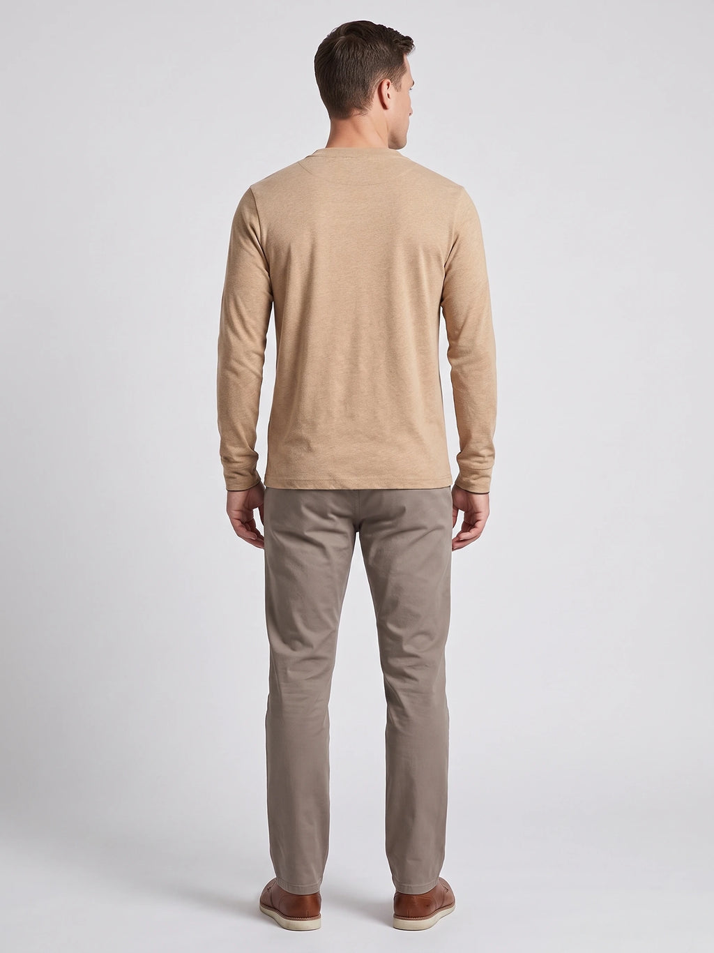 Rear studio view of a model wearing a Khaki cotton long sleeve Henley shirt.