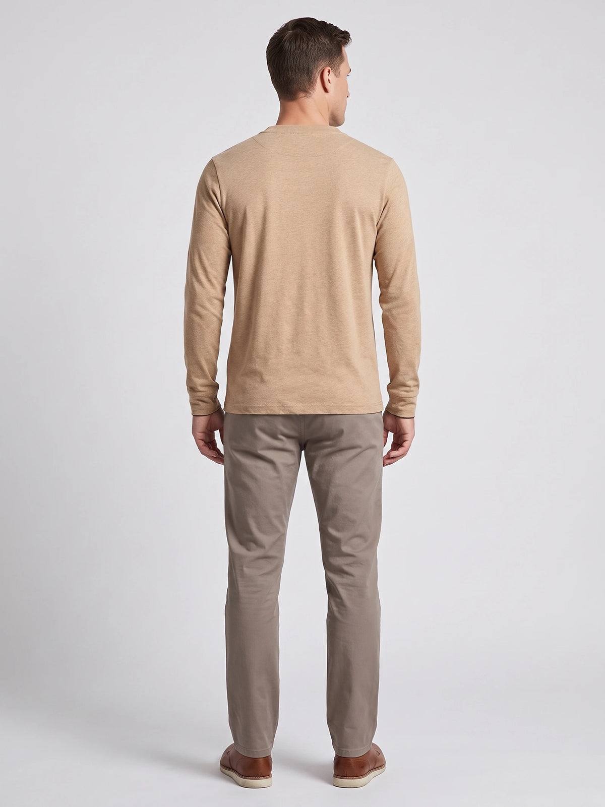 Rear studio view of a model wearing a Khaki cotton long sleeve Henley shirt.