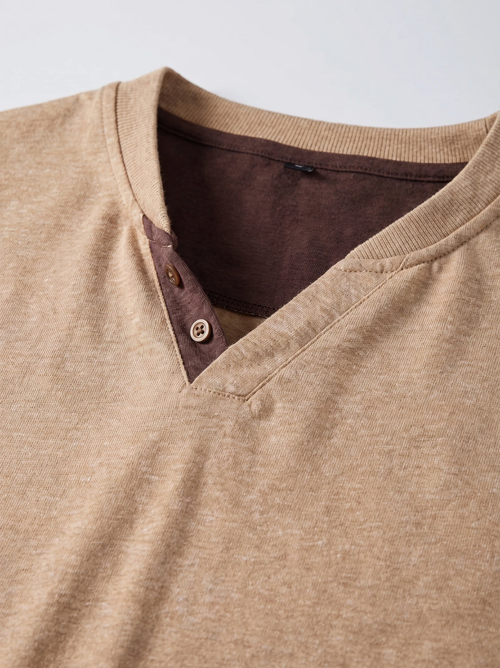 Close-up of the Khaki cotton Long Sleeve Henley Shirt, showing its ribbed neckline and two-button placket.