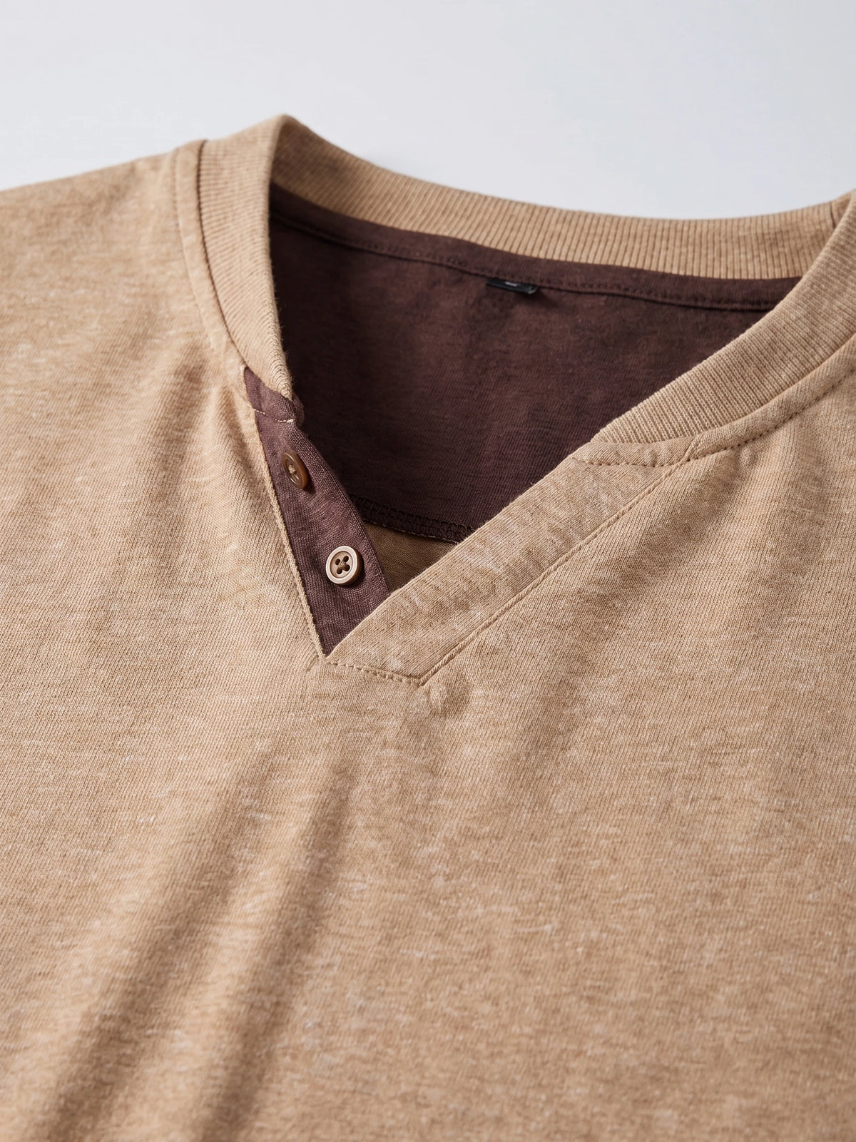 Close-up of the Khaki cotton Long Sleeve Henley Shirt, showing its ribbed neckline and two-button placket.