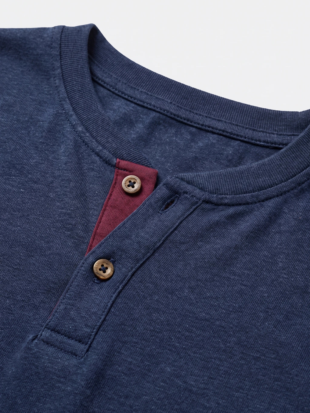 Close-up of the Navy cotton Long Sleeve Henley Shirt with a ribbed collar, two-button placket, and contrast inner trim.