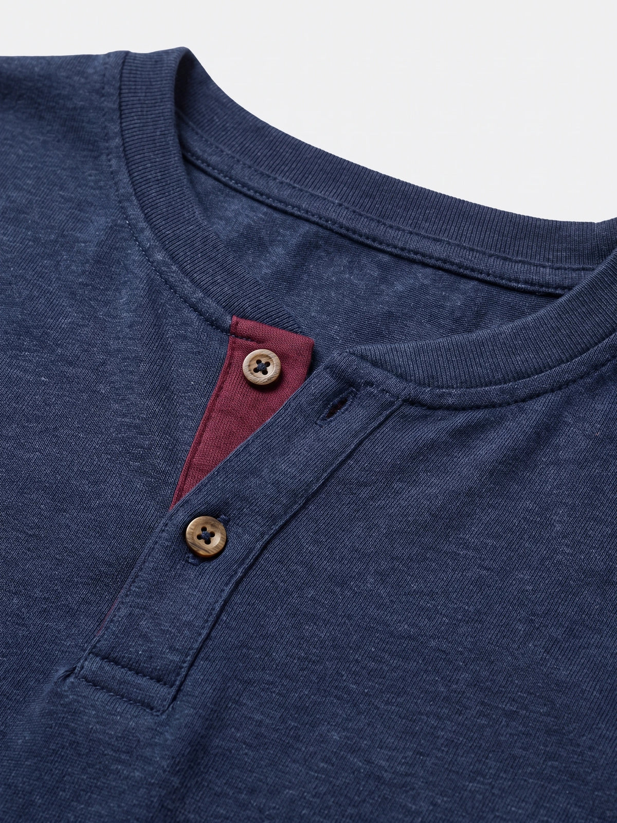 Close-up of the Navy cotton Long Sleeve Henley Shirt with a ribbed collar, two-button placket, and contrast inner trim.