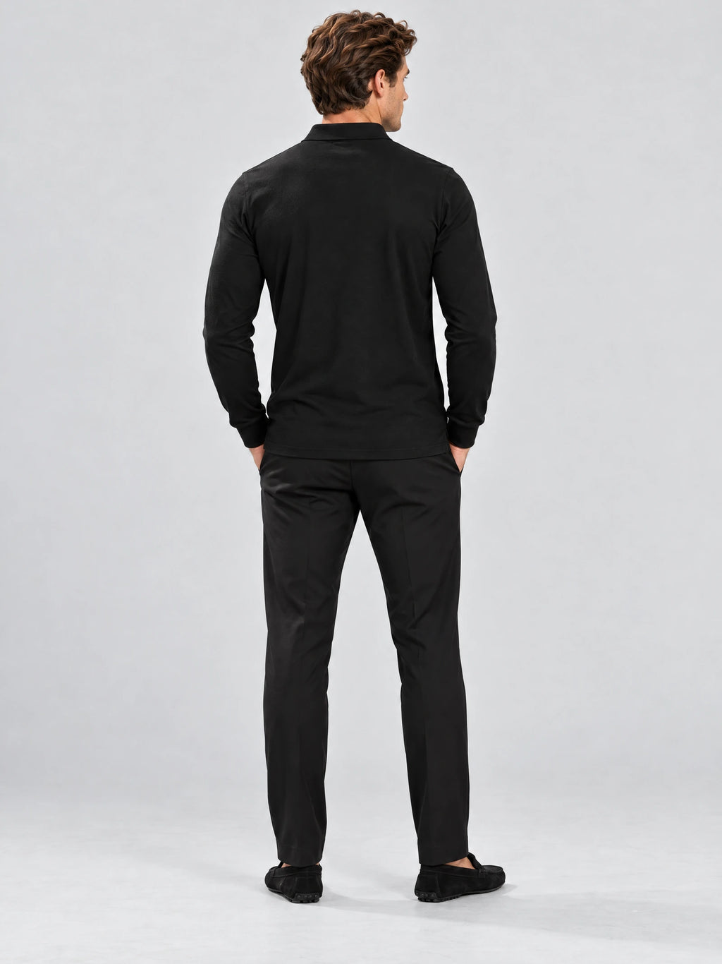 Rear studio view of a model wearing a Black Long Sleeve Polo with a smooth back and long sleeves.