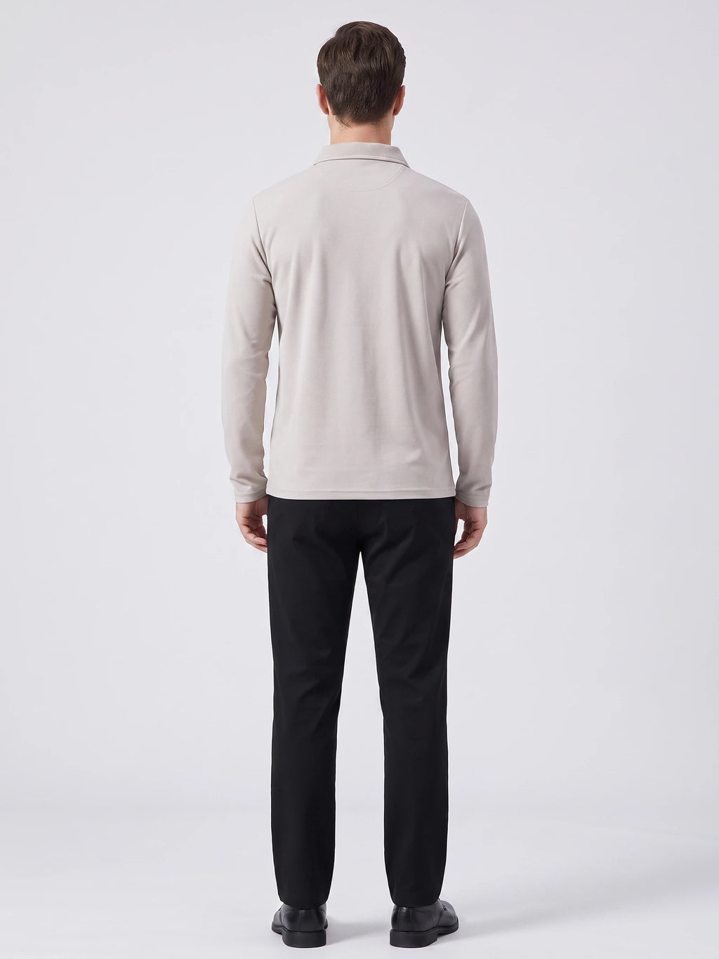 Rear studio view of a model wearing a Beige long sleeve polo shirt with a turn-down collar.