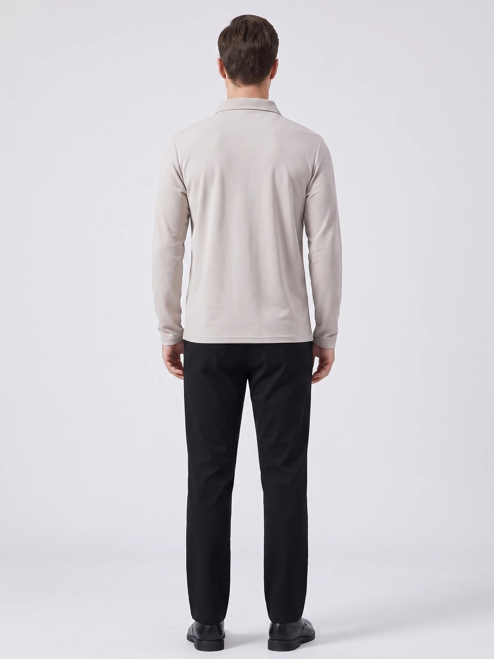 Rear studio view of a model wearing a Beige long sleeve polo shirt with a turn-down collar.