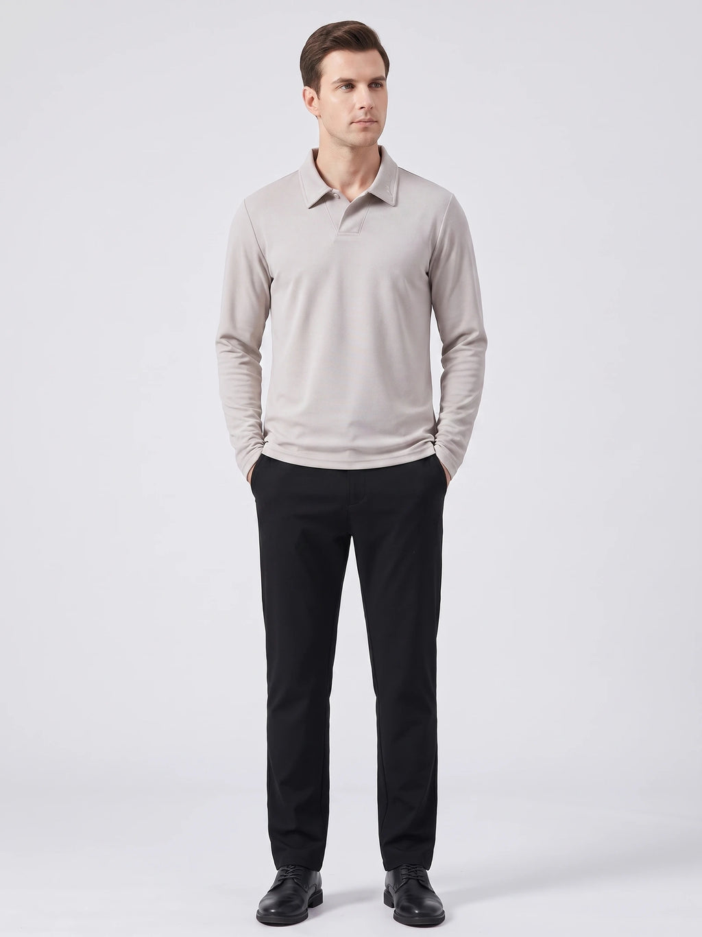 Model wearing a Beige long sleeve polo with an embroidered turn-down collar in a front studio view.