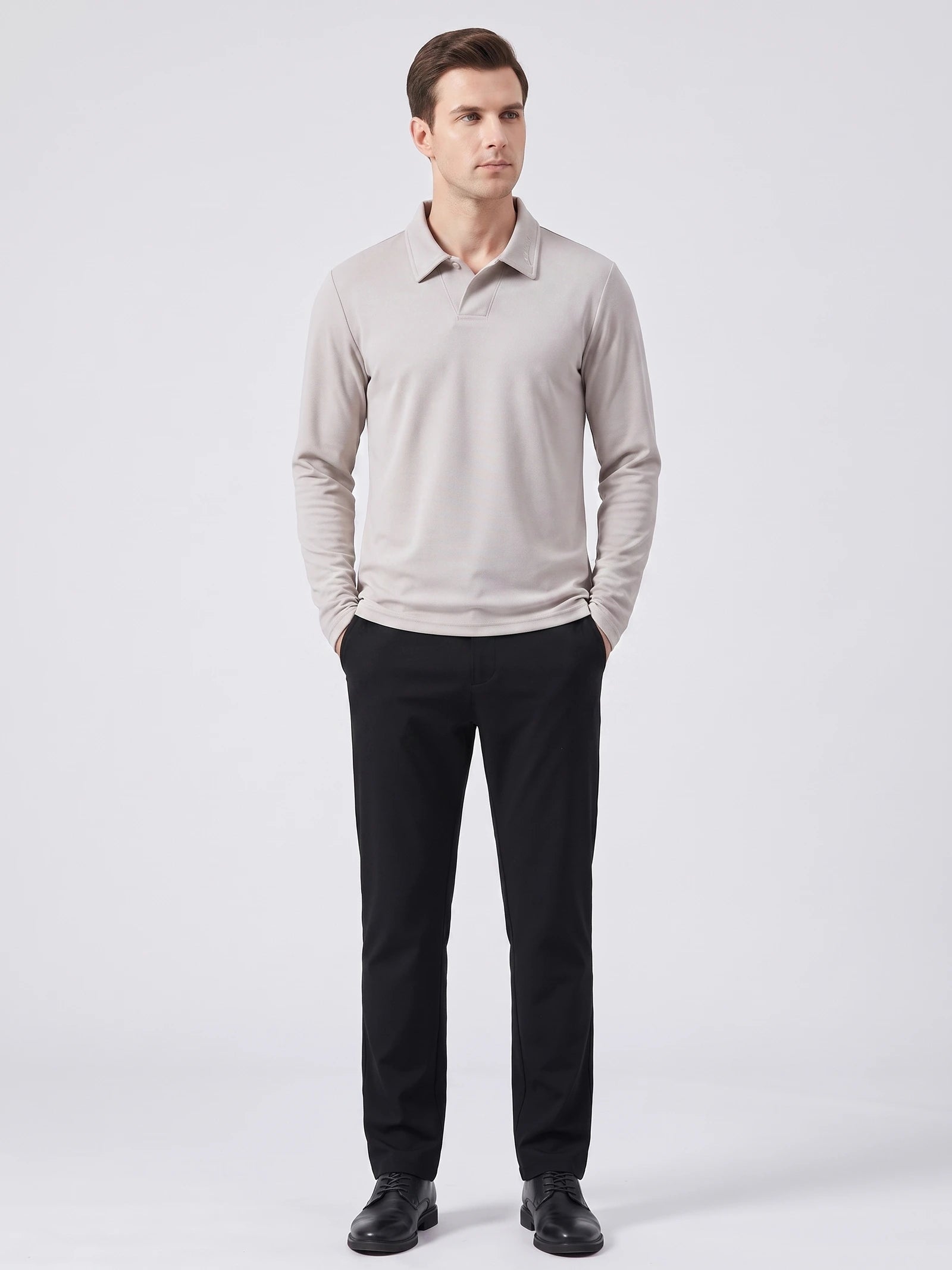 Model wearing a Beige long sleeve polo with an embroidered turn-down collar in a front studio view.