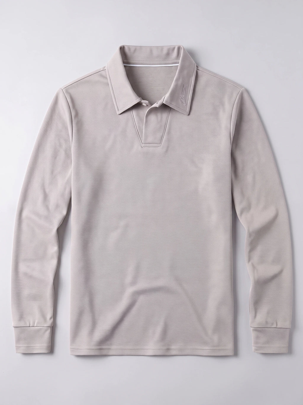 Beige men's long sleeve polo laid flat, featuring a textured knit, embroidered turn-down collar, and button placket.