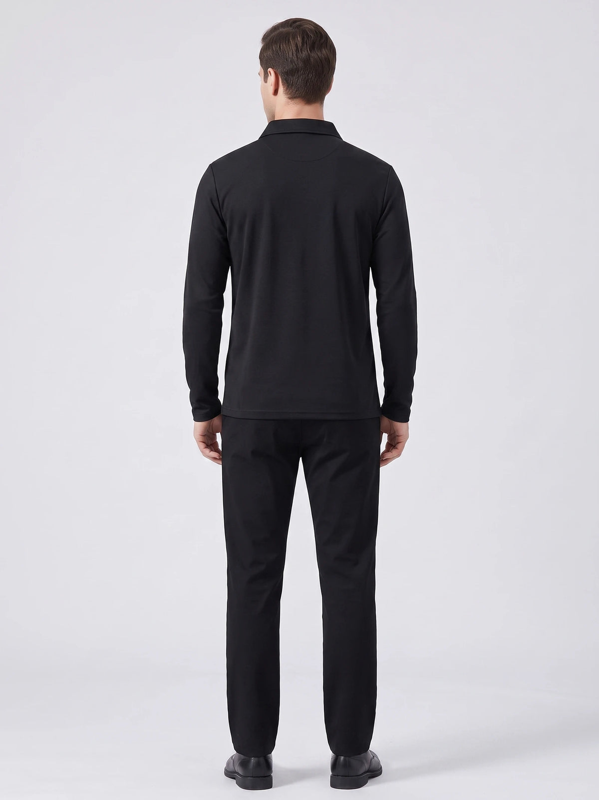Rear studio view of a model wearing a Black long sleeve polo shirt with a turn-down collar.