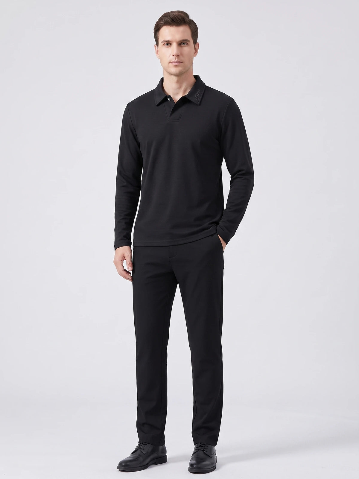 Front studio view of a model wearing a Black long sleeve polo with an embroidered turn-down collar.
