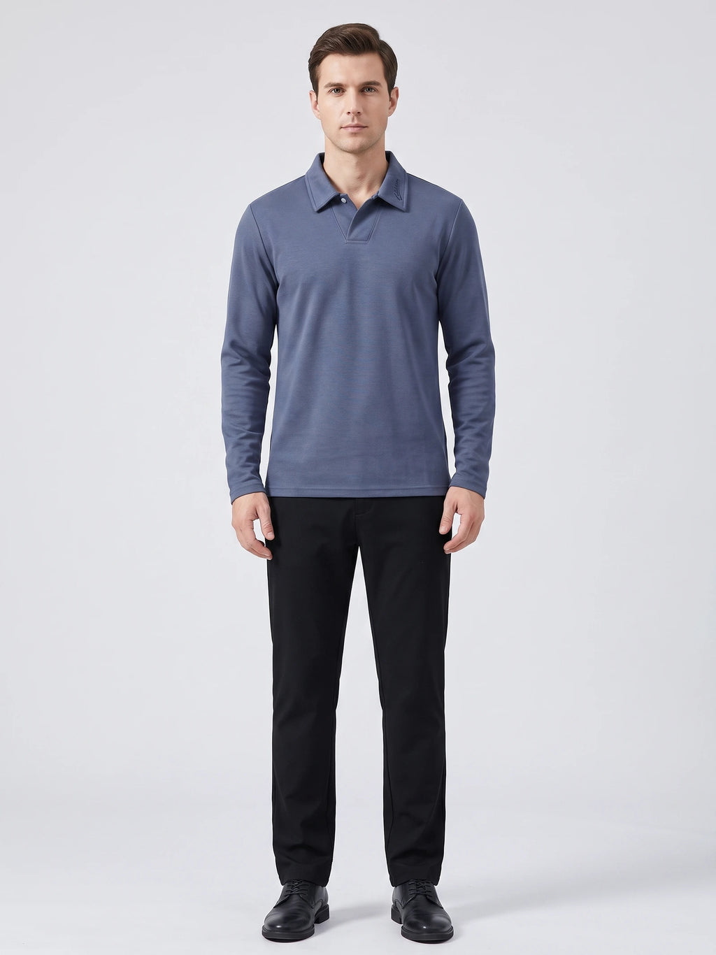 Front studio view of a model wearing a Blue long sleeve polo with an embroidered turn-down collar.