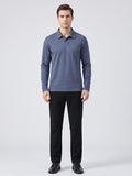 Front studio view of a model wearing a Blue long sleeve polo with an embroidered turn-down collar.