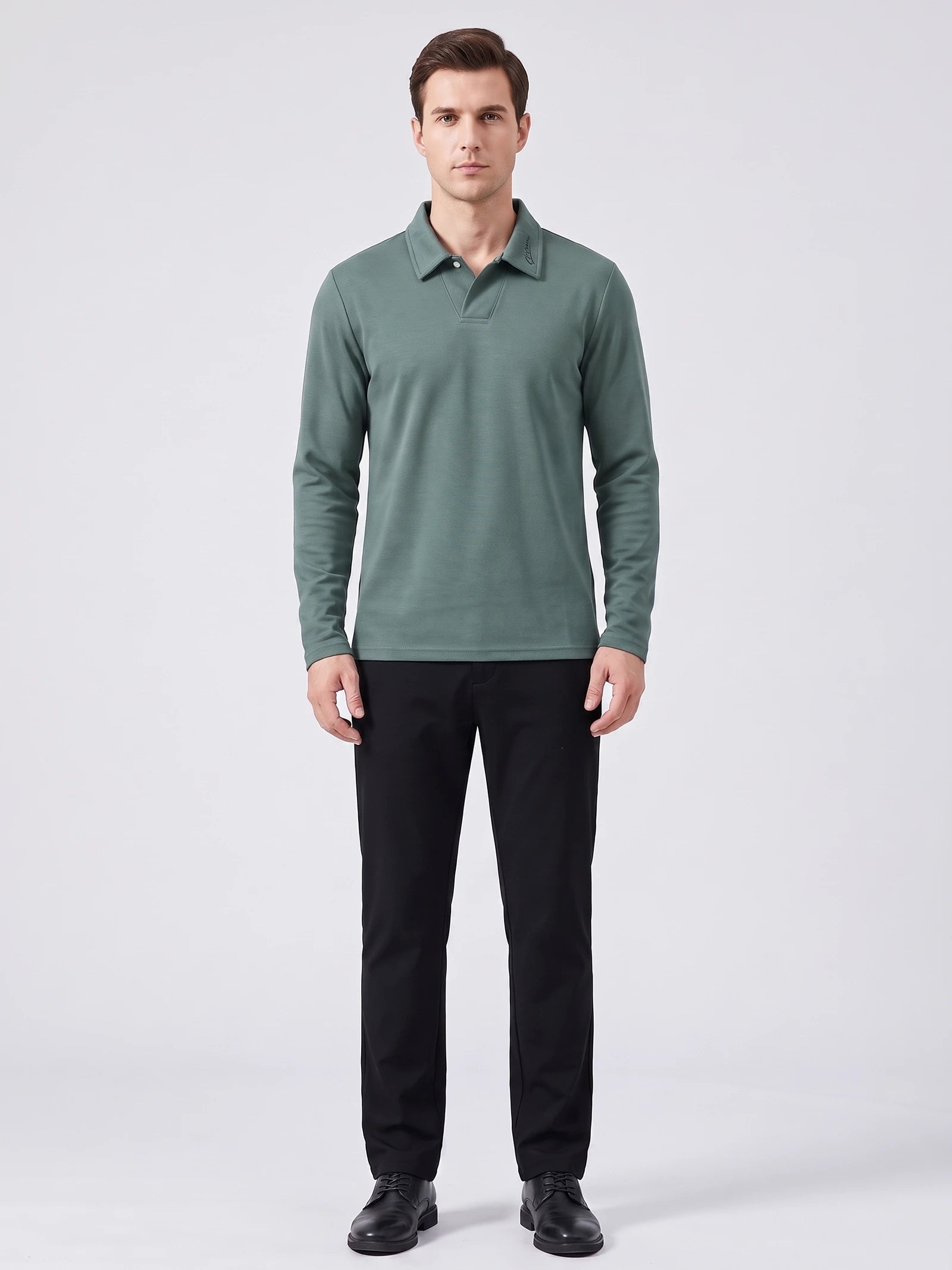 Front studio view of a model wearing a Green long sleeve polo with a turn-down collar and button placket.