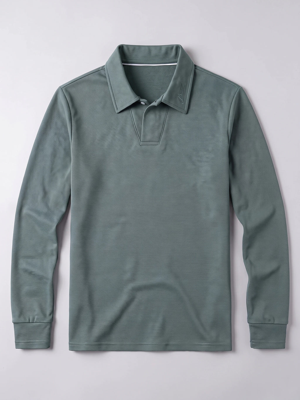 Green long sleeve polo shirt laid flat, featuring a turn-down collar, button placket, and ribbed cuffs.
