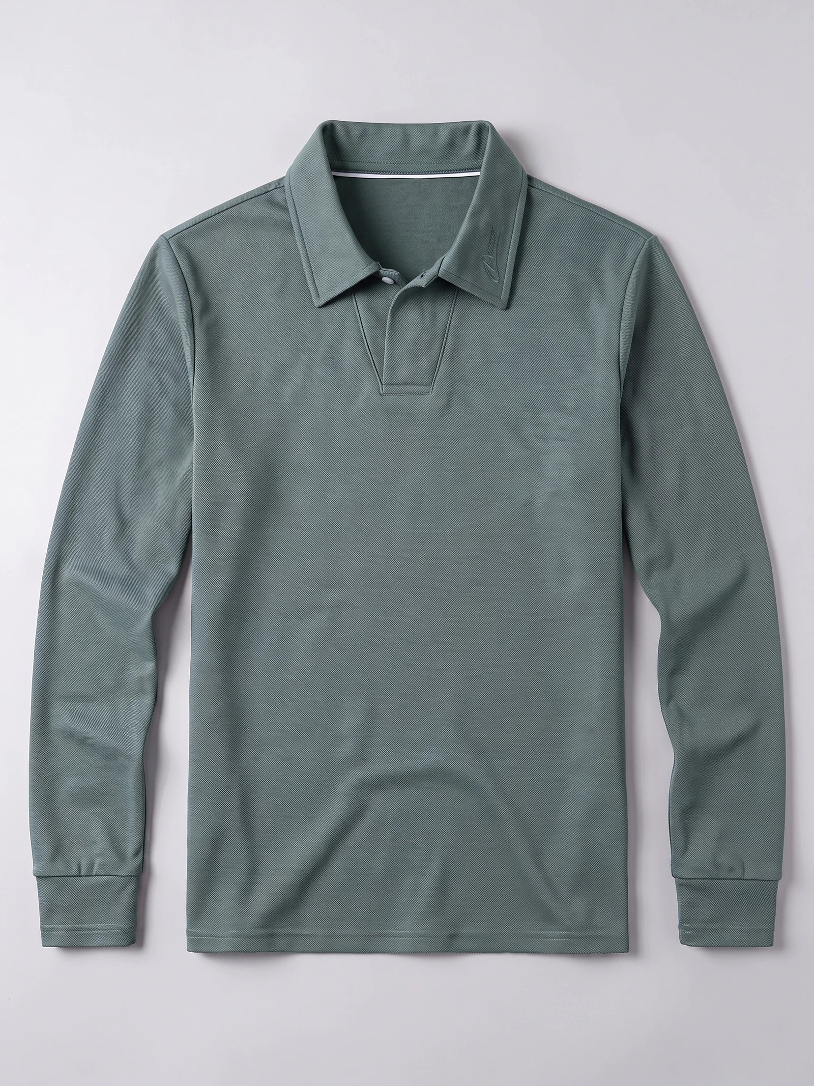 Green long sleeve polo shirt laid flat, featuring a turn-down collar, button placket, and ribbed cuffs.