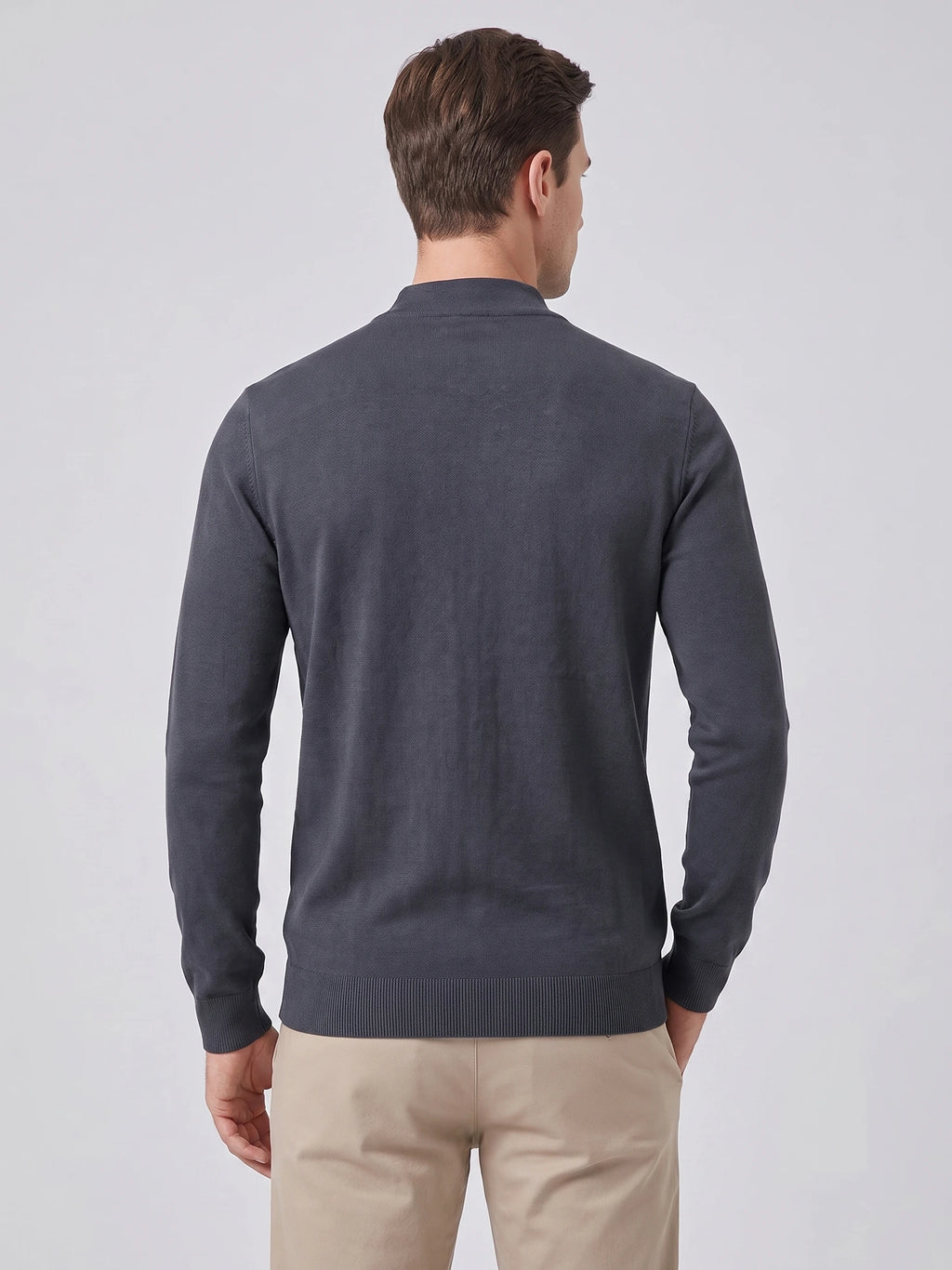 Rear studio view of a model wearing a Gray mock neck sweater with ribbed cuffs and hem.