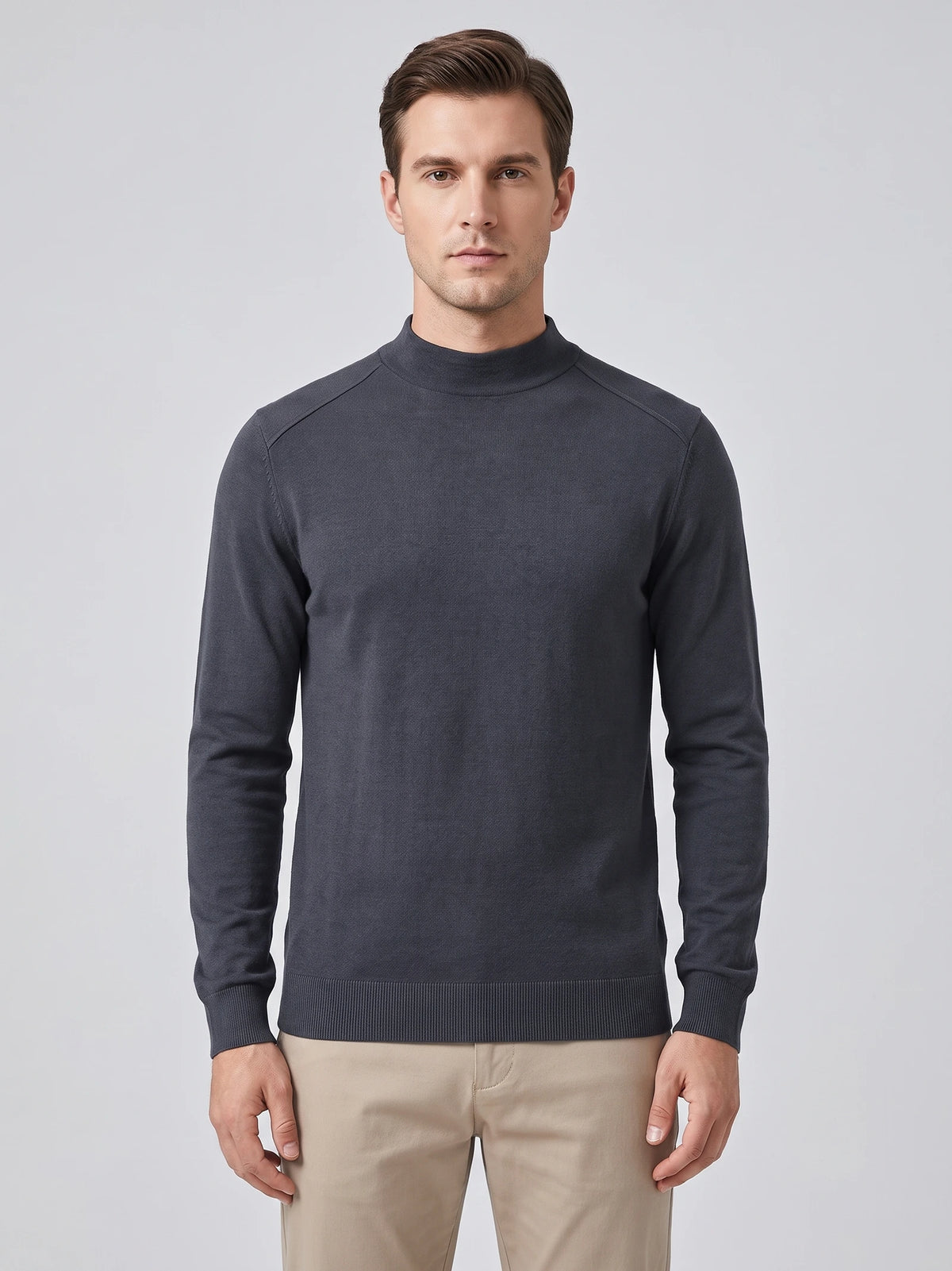 Front studio view of a model wearing a Gray Mock Neck Sweater with raglan seams and ribbed cuffs and hem.