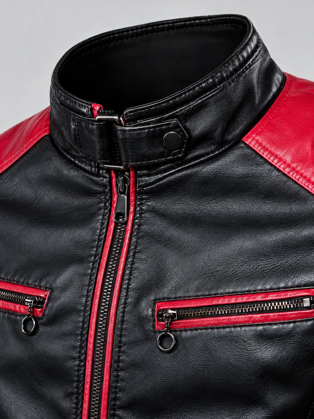 Red Moto Leather Jacket detail showing a stand collar with buckle tab, front zipper, and zippered chest pockets.