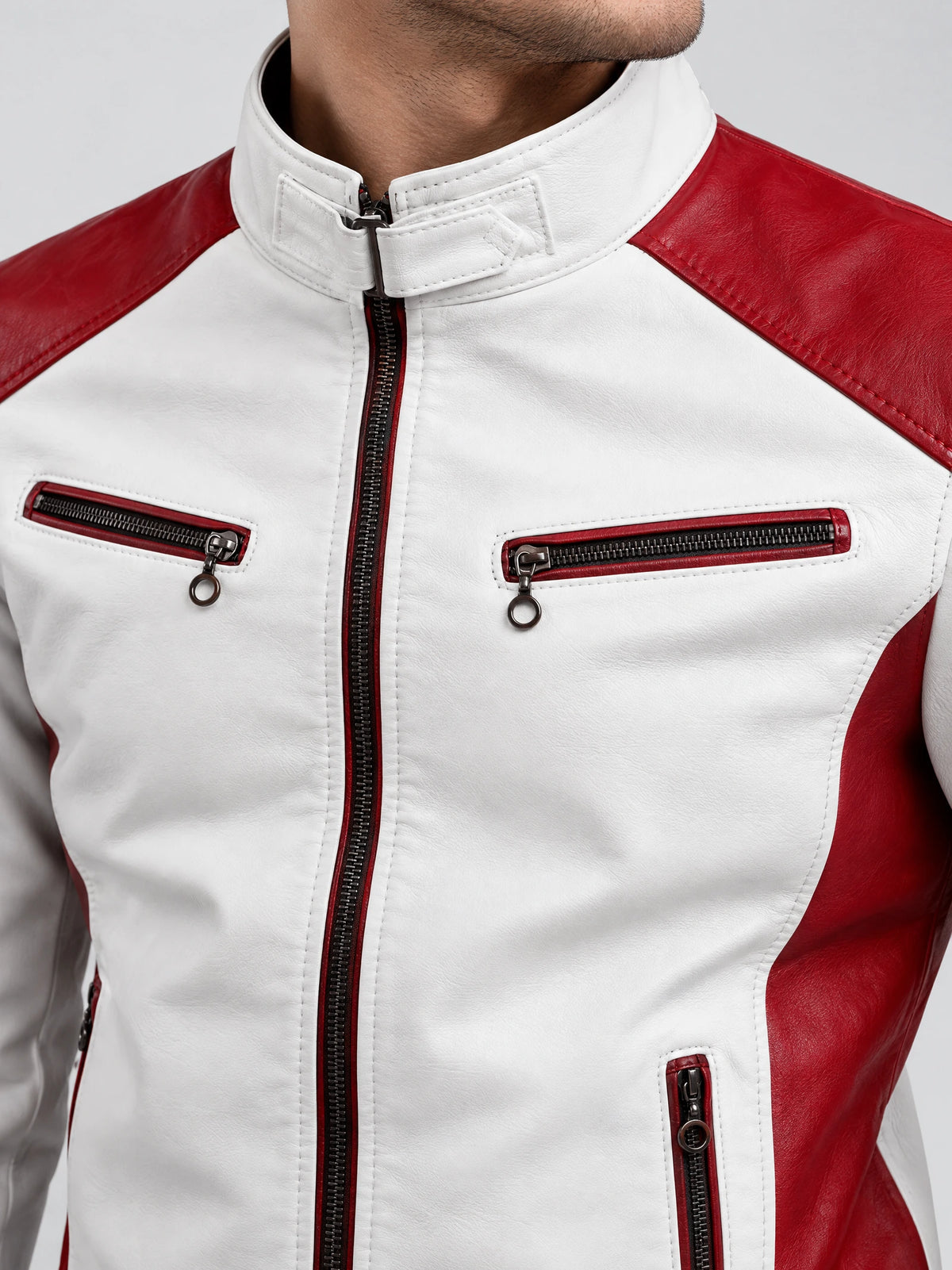 Close-up of a White Moto Leather Jacket showing the stand collar tab, front zipper, and zippered chest pockets.
