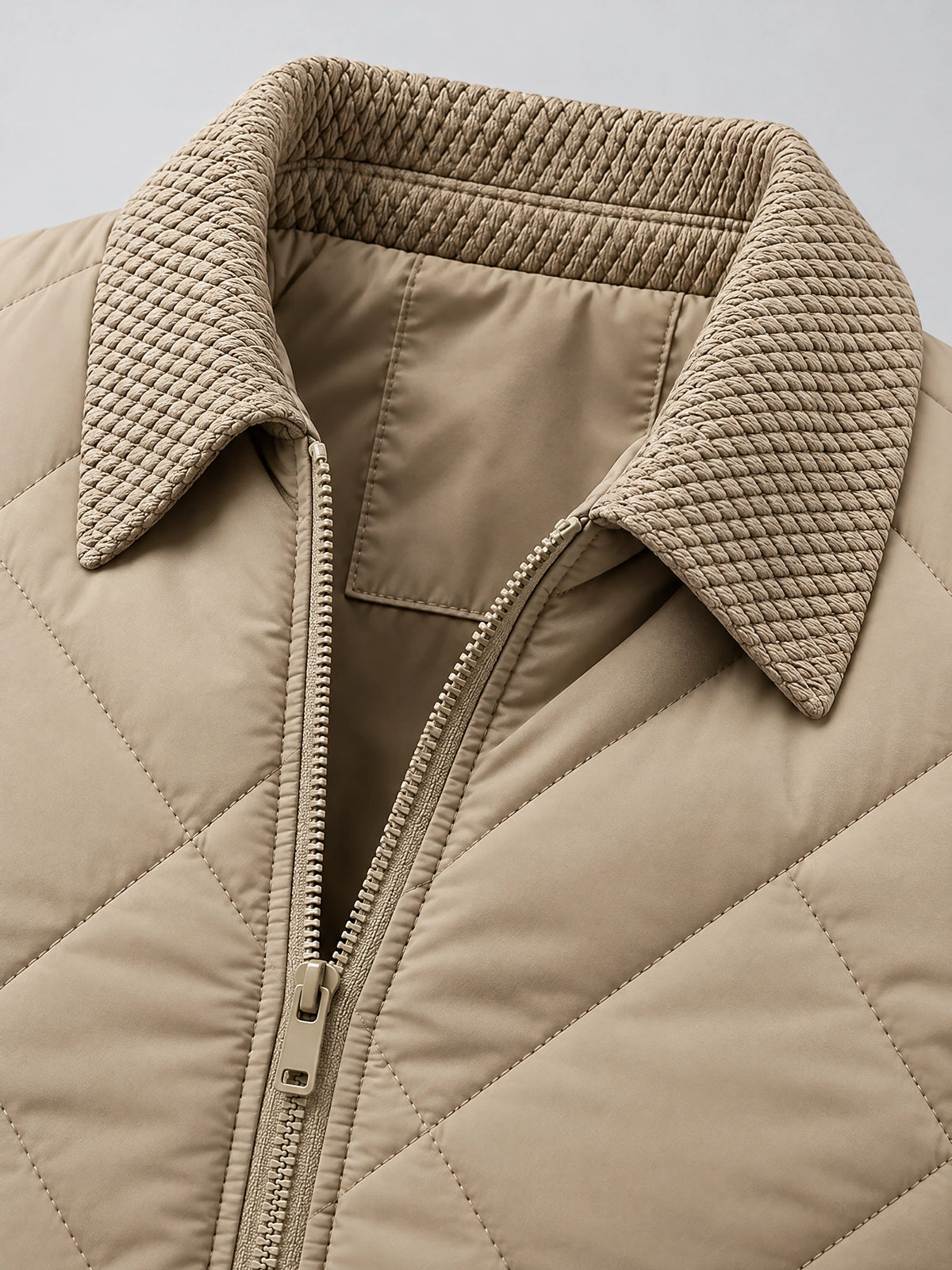 Close-up of the Beige Men Padded Lapel Jacket showing its textured lapel collar, front zipper, and quilted stitching.