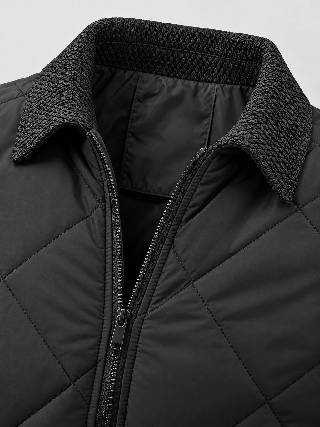 Close-up of the Black Men Padded Lapel Jacket showing its textured lapel collar, front zipper, and quilted stitching.