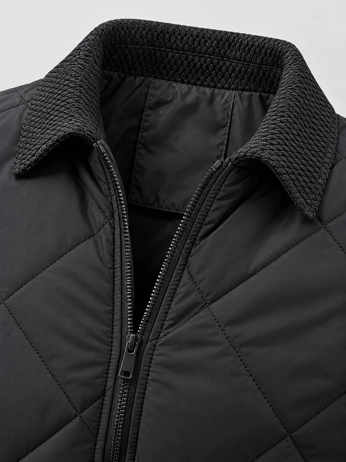 Close-up of the Black Men Padded Lapel Jacket showing its textured lapel collar, front zipper, and quilted stitching.