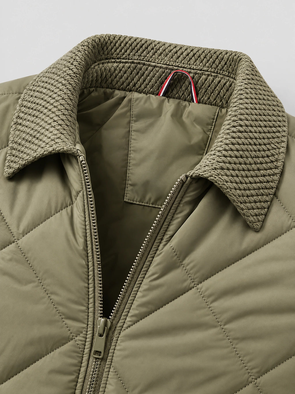 Green Men Padded Lapel Jacket close-up showing the textured lapel collar, quilted stitching, and front zipper.