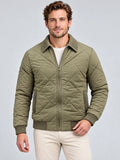 Front studio view of a model wearing a Green Men Padded Lapel Jacket with diamond quilting, zip closure, and textured lapel collar.