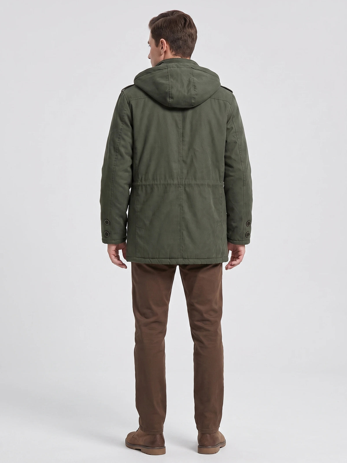 Rear studio view of a model wearing a Dark Green men's parka with a hood, back seam detailing, and buttoned cuffs.