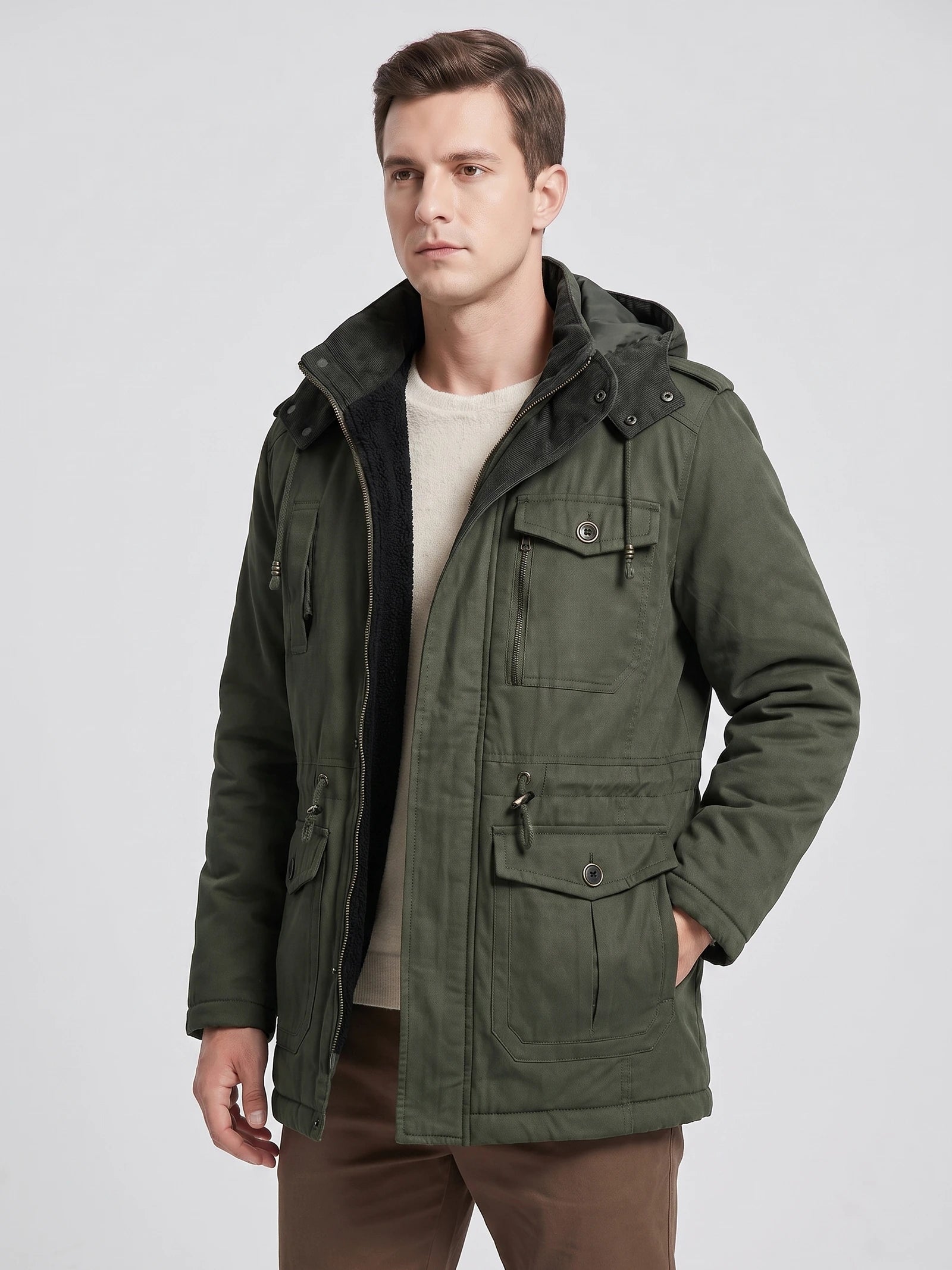 Model wearing a Dark Green men’s Parkas jacket in a front studio view, showing the hood, fleece lining, zip closure, and flap pockets.