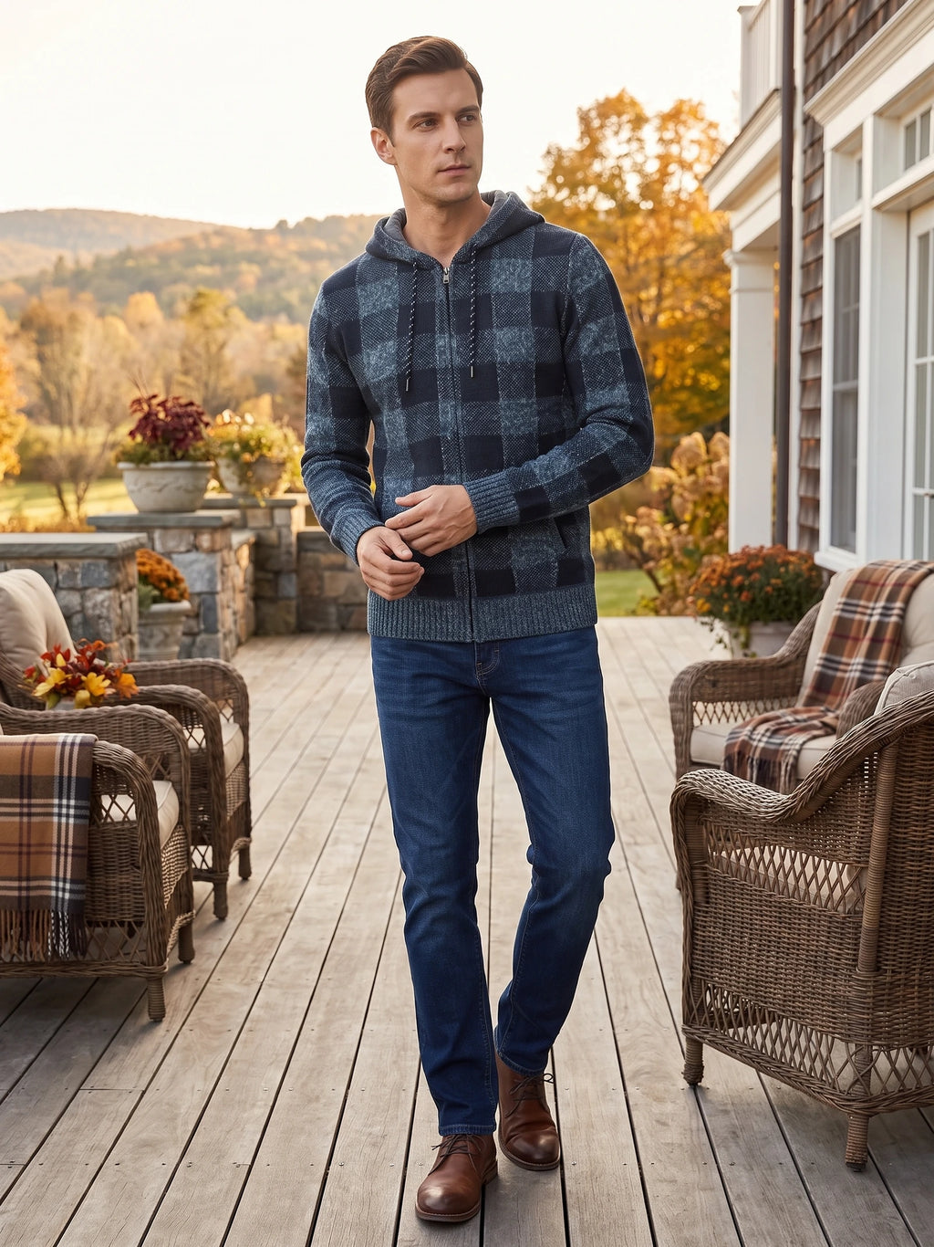 Man wearing a Blue Plaid Flannel hooded zip-front jacket while walking on a patio beside a house.