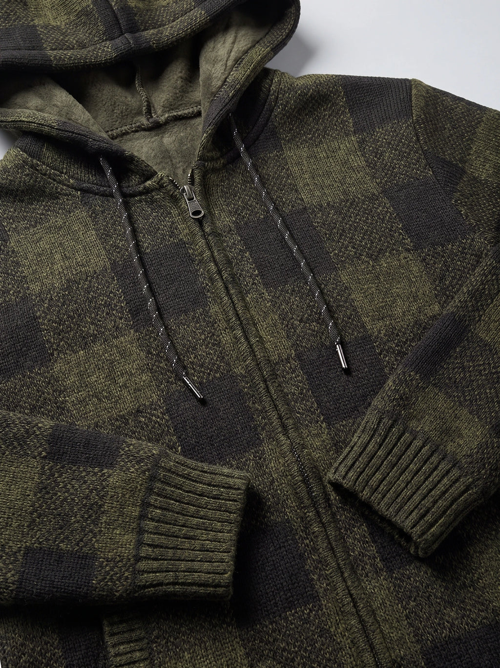 Green plaid flannel men’s hooded jacket detail showing the fleece-lined hood, front zipper, drawstrings, and ribbed cuffs.