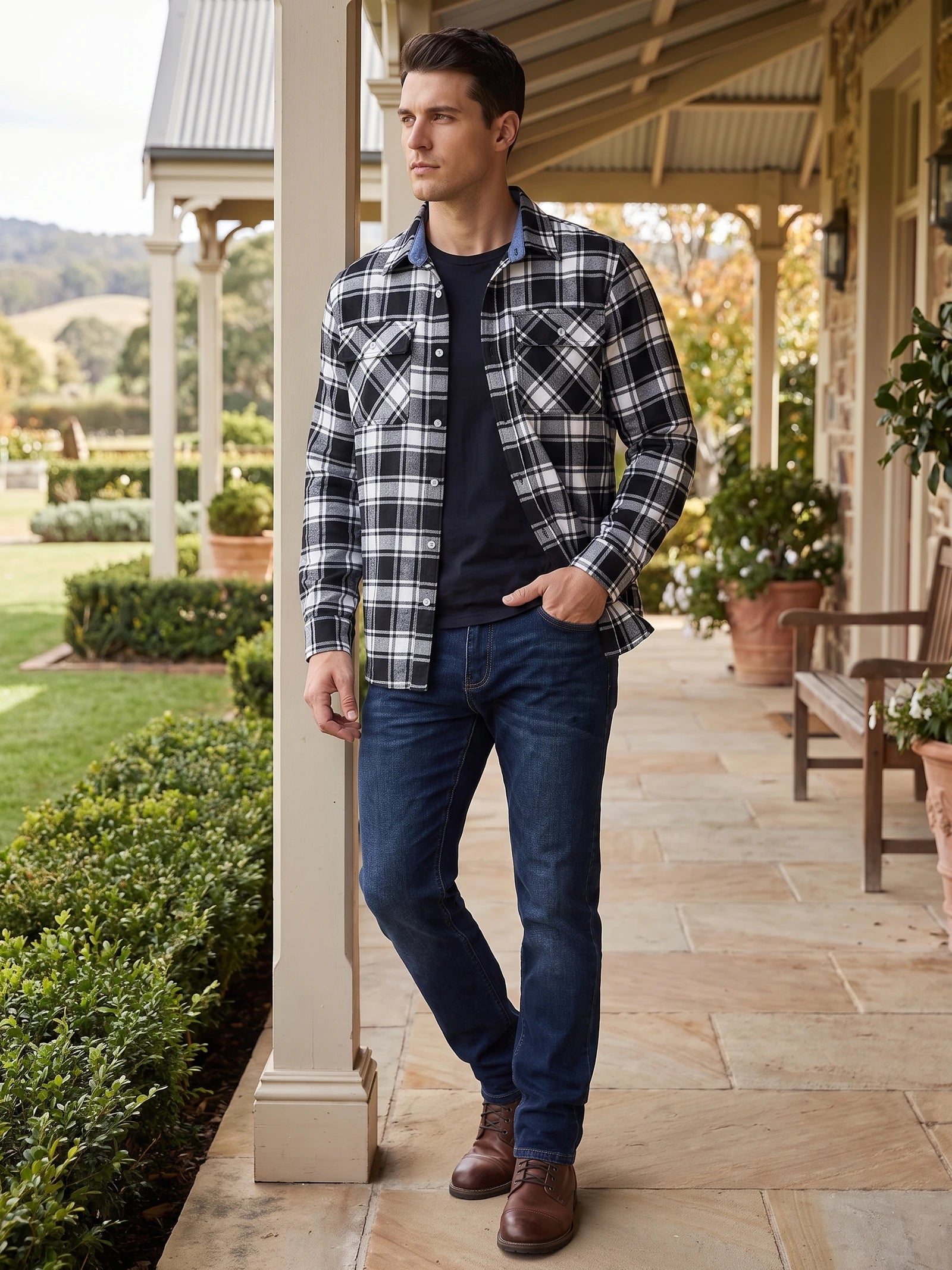 Model wearing a Black plaid flannel shirt jacket with buttoned chest pockets on a covered porch.