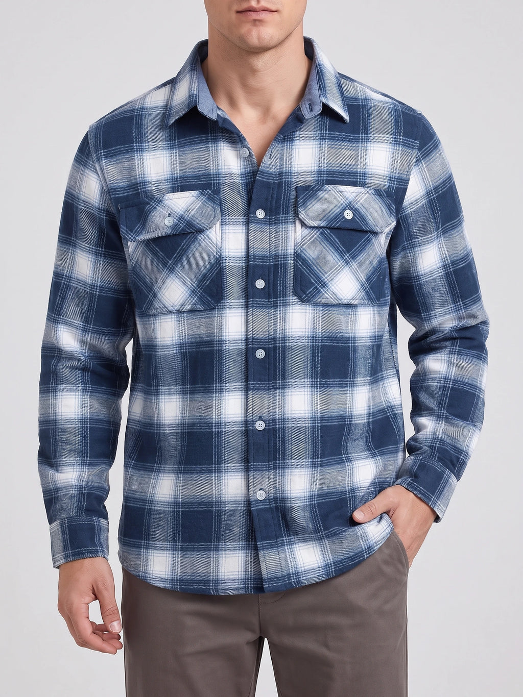 Front studio view of a model wearing a Blue plaid flannel shirt jacket with long sleeves, button closure, and two button-flap chest pockets.