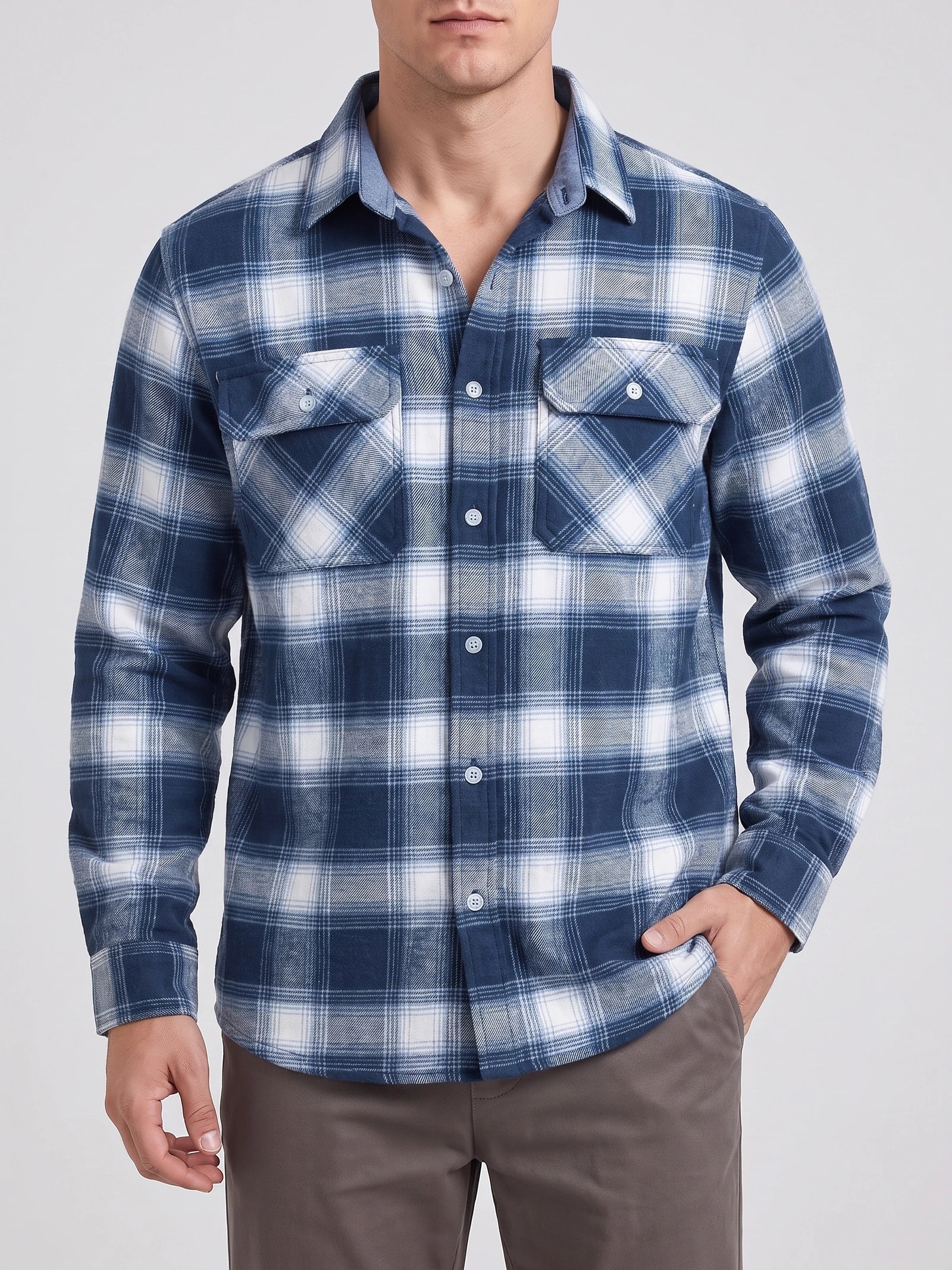 Front studio view of a model wearing a Blue plaid flannel shirt jacket with long sleeves, button closure, and two button-flap chest pockets.