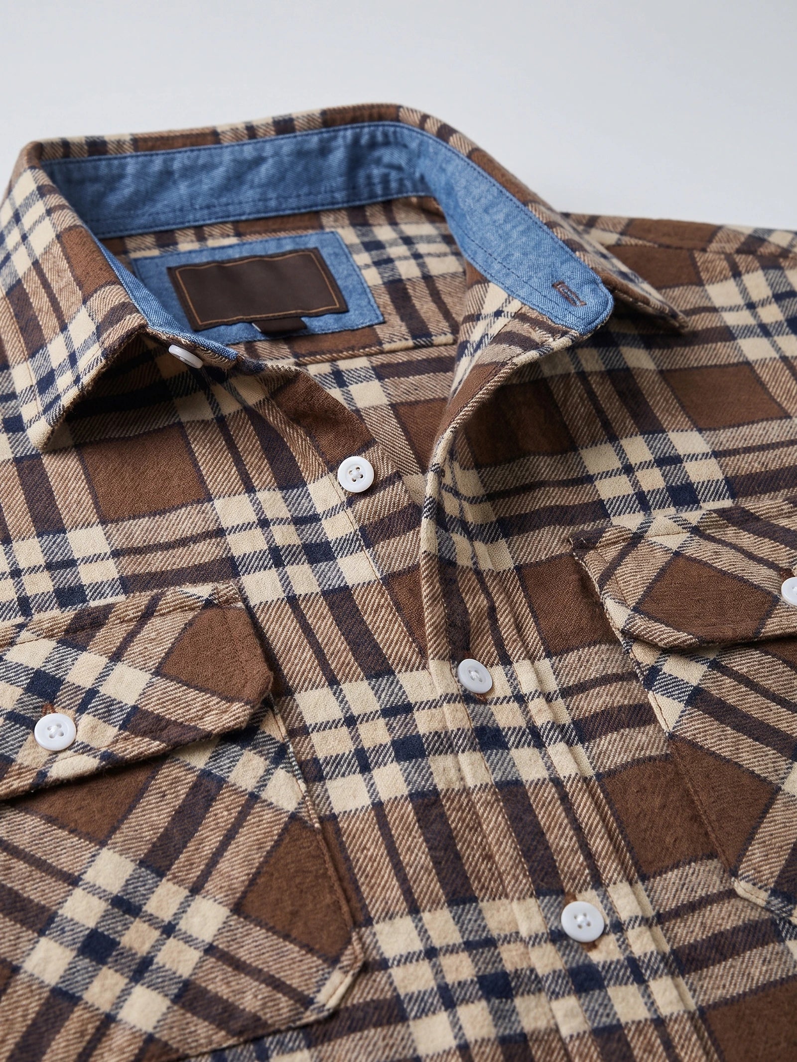 Close-up of the Brown Plaid Flannel Shirt collar, button placket, and chest pockets.