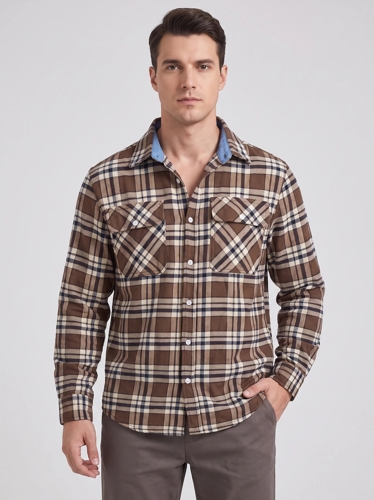 Front studio view of a model wearing a Brown plaid flannel shirt with long sleeves, button front, and two chest pockets.