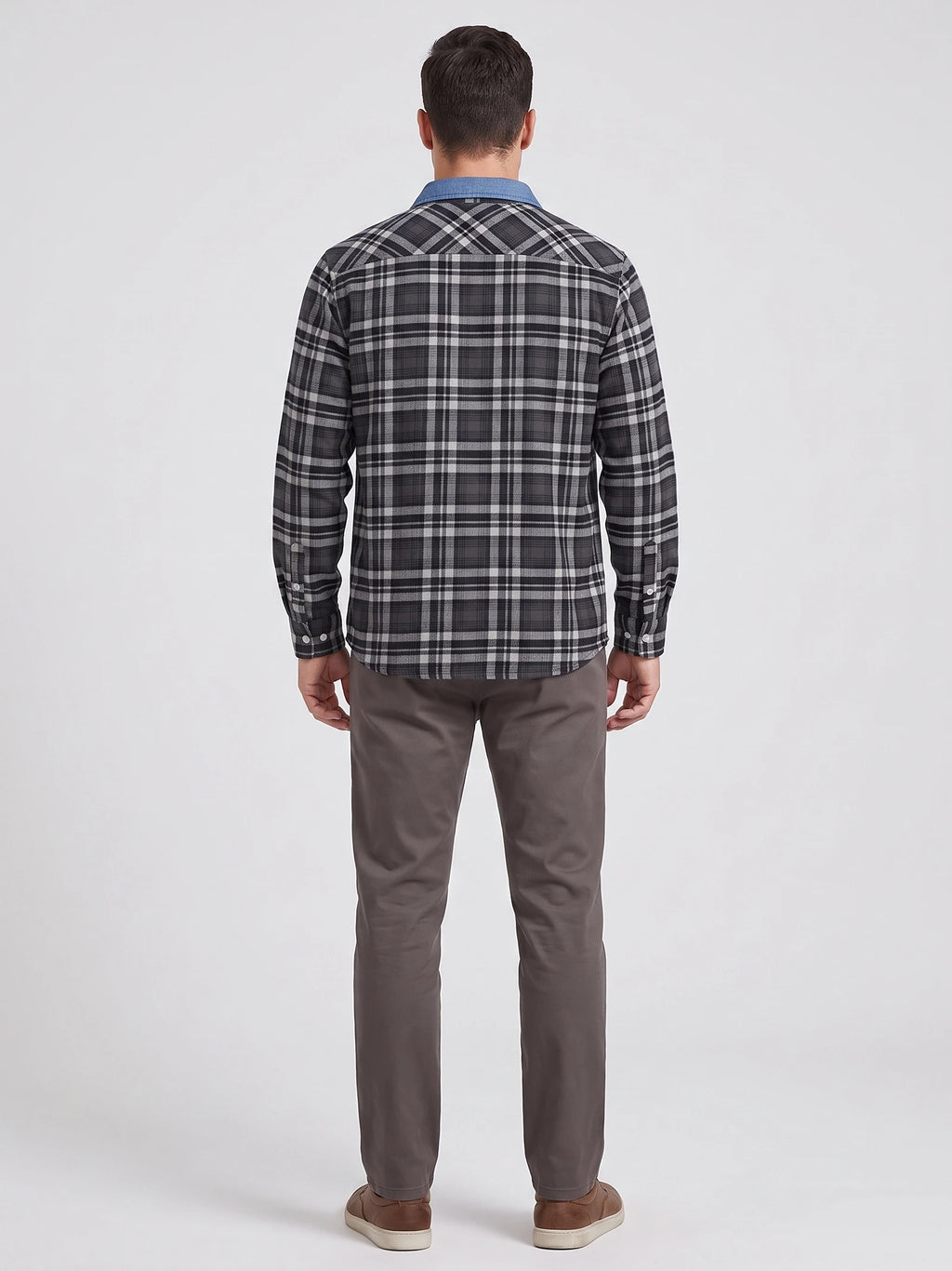 Rear studio view of a model wearing a Dark Gray plaid flannel shirt with long sleeves and button cuffs.