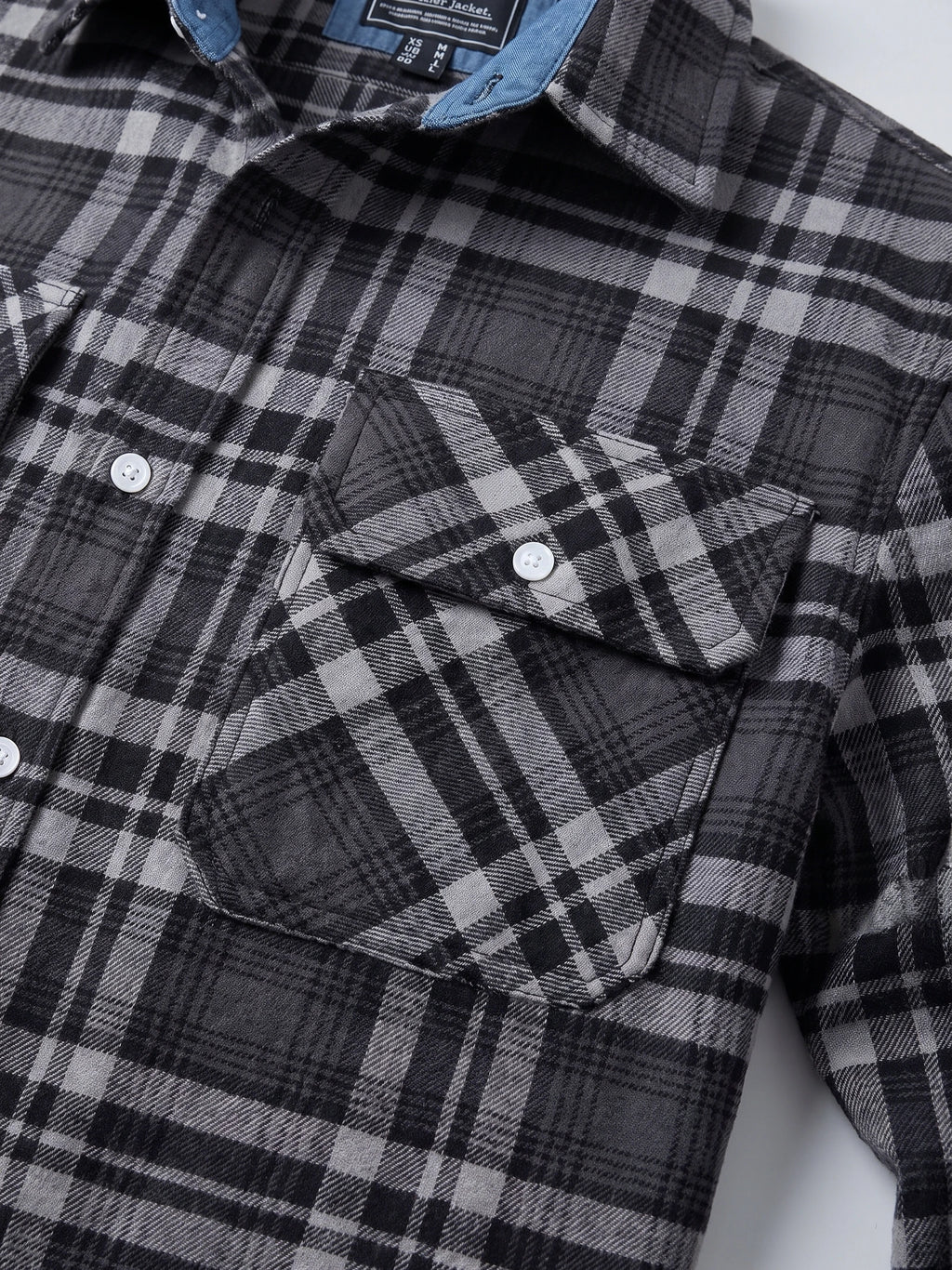 Close-up of the Dark Gray Plaid Flannel Shirt showing button-flap chest pockets, collar, and textured plaid fabric.