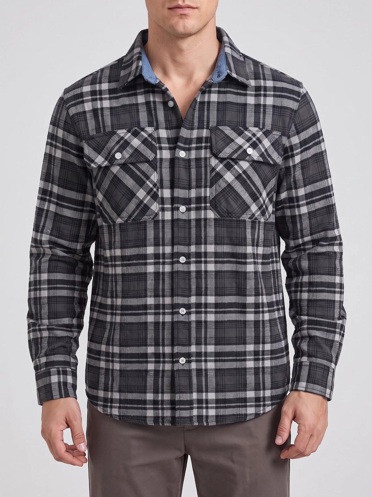 Front studio view of a model wearing a Dark Gray Plaid Flannel Shirt with long sleeves, button front, and two chest pockets.