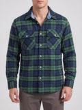 Front studio view of a model wearing a Green plaid flannel shirt jacket with long sleeves, button-front closure, and two flap chest pockets.