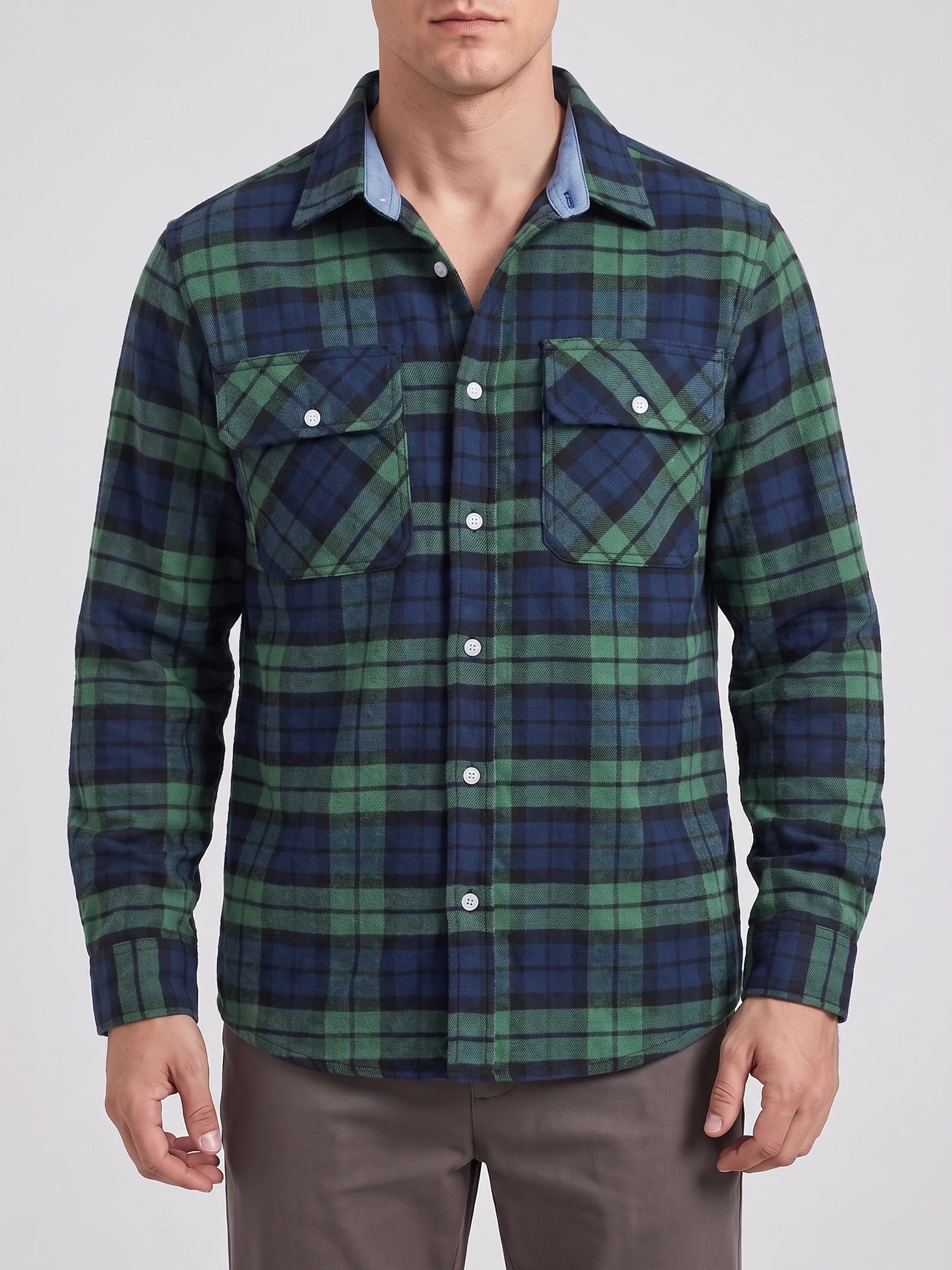 Front studio view of a model wearing a Green plaid flannel shirt jacket with long sleeves, button-front closure, and two flap chest pockets.