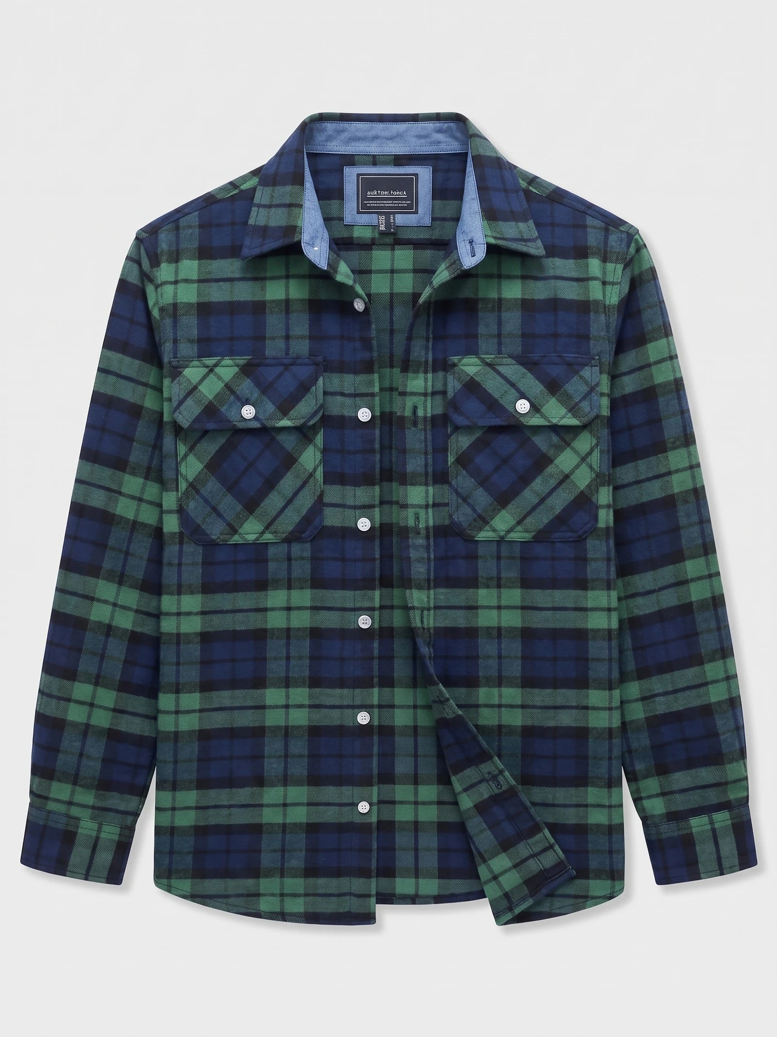 Green plaid flannel shirt laid flat, showing a button-down front, pointed collar, and two button-flap chest pockets.