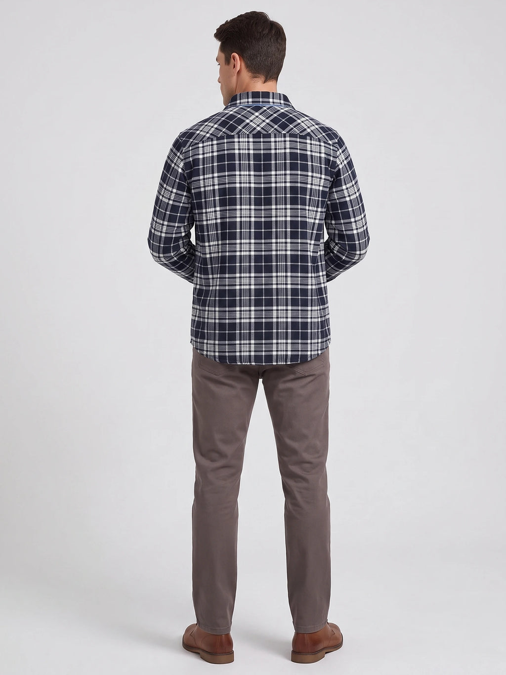 Rear studio view of a model wearing a Navy Plaid Flannel Shirt with long sleeves and a curved hem.