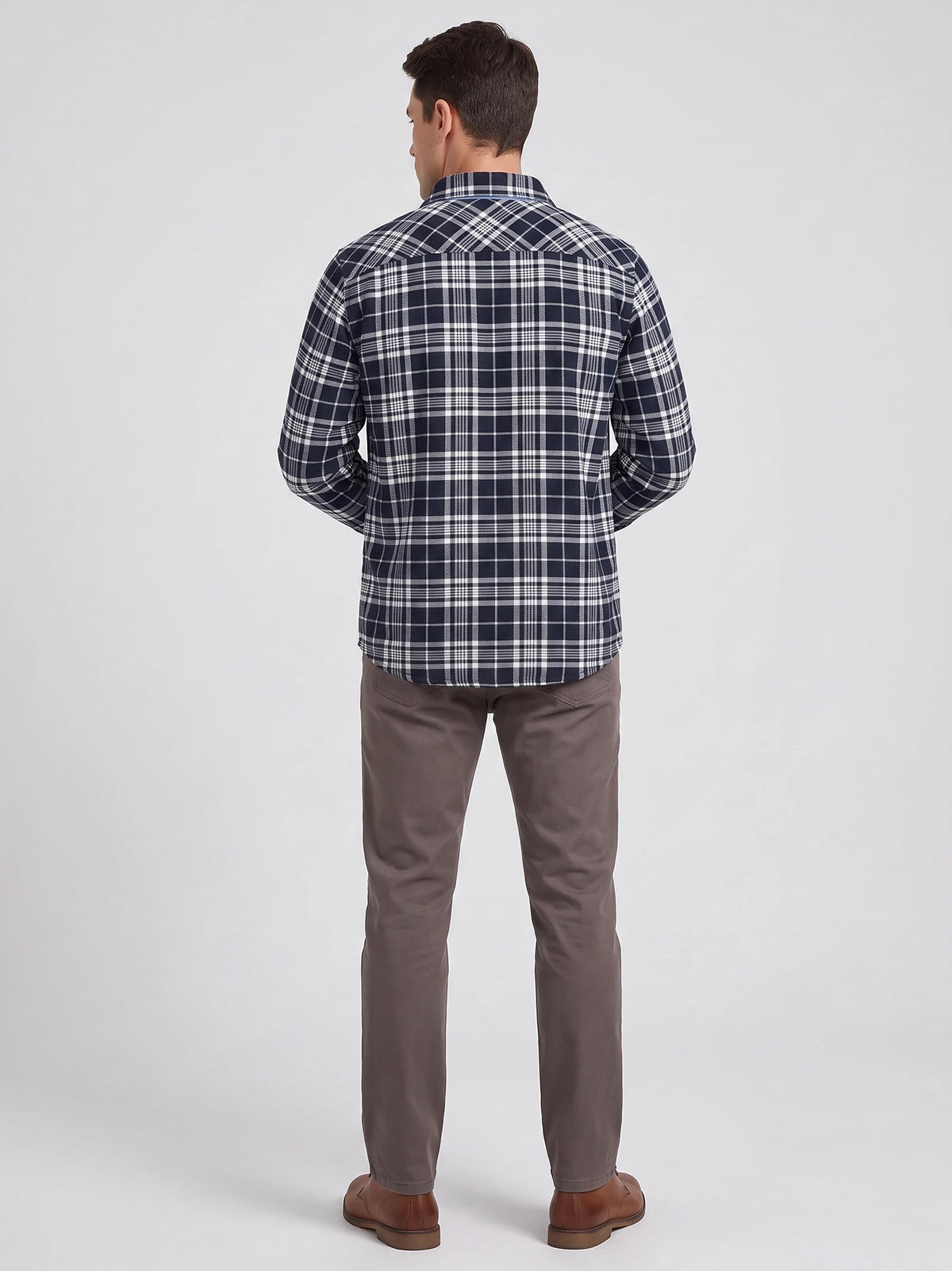 Rear studio view of a model wearing a Navy Plaid Flannel Shirt with long sleeves and a curved hem.