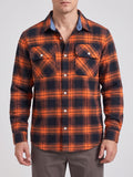 Front studio view of a model wearing an Orange plaid flannel shirt with long sleeves, button front, and two chest pockets.
