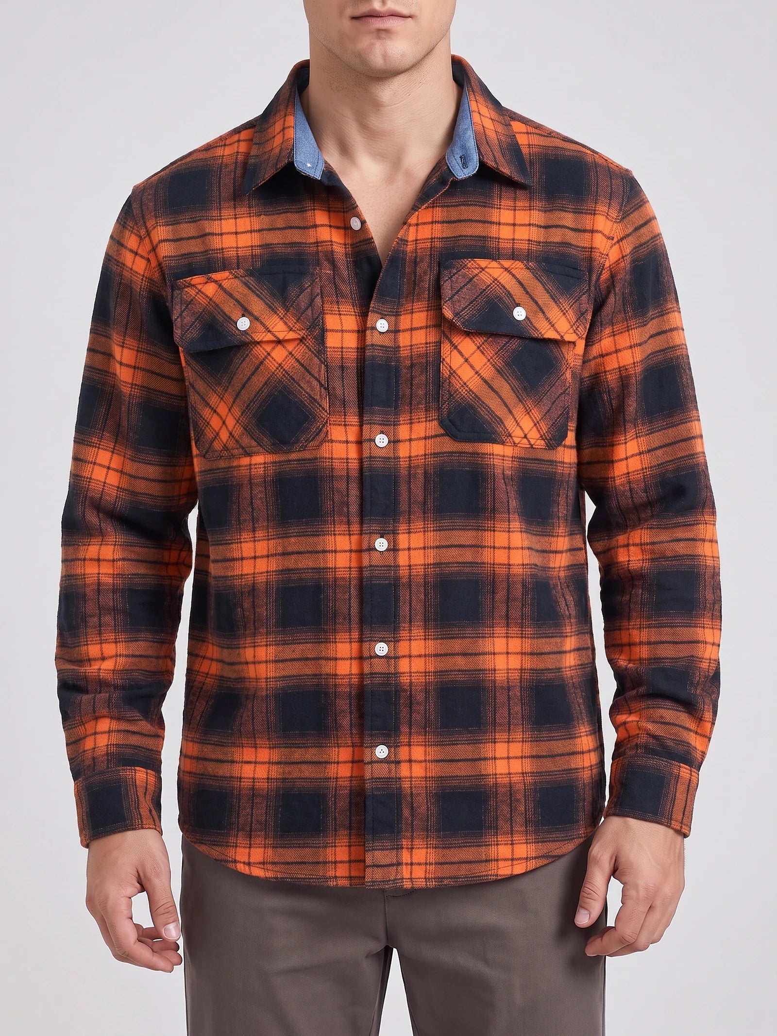Front studio view of a model wearing an Orange plaid flannel shirt with long sleeves, button front, and two chest pockets.