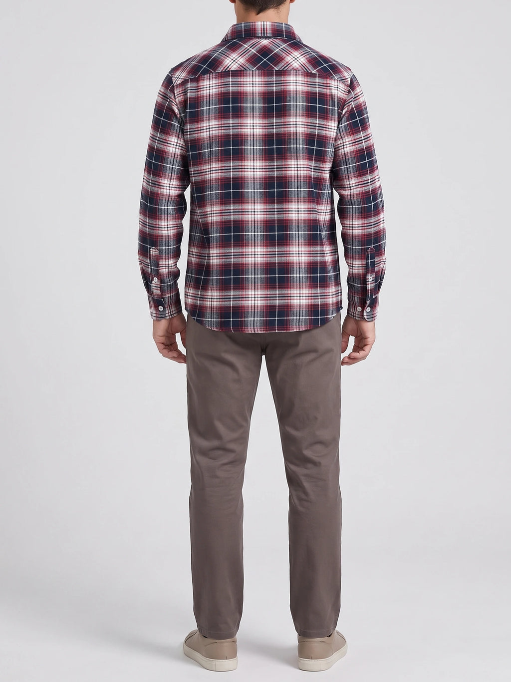 Rear studio view of a model wearing a Red plaid flannel shirt with long sleeves and a curved hem.
